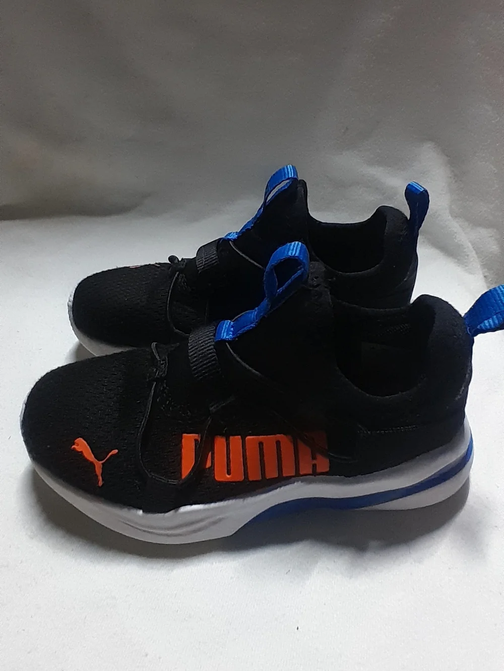 Puma Kids Black Sneakers with Orange Logo and Blue Accents